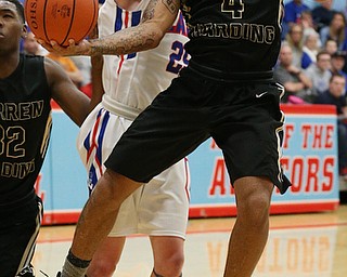 MICHAEL G TAYLOR | THE VINDICATOR- 03-11-17  -Basketball- 2nd qtr., Harding's #4 Lynn Bowden drives against #25 Jake Maranville. D1 District Final- Warren G. Harding Raiders vs Uniontown Lake Blue Streaks at Alliance High School in Alliance, OH