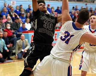 MICHAEL G TAYLOR | THE VINDICATOR- 03-11-17  -Basketball-  2nd qtr, Harding's #30 Mike Hughes drives the lane against Lake's #31 Josh Hutcherson. D1 District Final- Warren G. Harding Raiders vs Uniontown Lake Blue Streaks at Alliance High School in Alliance, OH