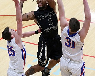 MICHAEL G TAYLOR | THE VINDICATOR- 03-11-17  -Basketball- 4th qtr, Harding's #4 Lynn Bowden shoots between Lake's #31 Josh Hutcherson and #25 Jake Maranville. D1 District Final- Warren G. Harding Raiders vs Uniontown Lake Blue Streaks at Alliance High School in Alliance, OH