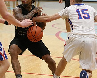 MICHAEL G TAYLOR | THE VINDICATOR- 03-11-17  -Basketball- OT, Harding's #4 Lynn Bowden has the ball knocked away by Lake's #15 Joe McBride. D1 District Final- Warren G. Harding Raiders vs Uniontown Lake Blue Streaks at Alliance High School in Alliance, OH