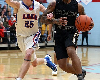 MICHAEL G TAYLOR | THE VINDICATOR- 03-11-17  -Basketball- OT, Harding's #4 Lynn Bowden drives against #25 Jake Maranville. D1 District Final- Warren G. Harding Raiders vs Uniontown Lake Blue Streaks at Alliance High School in Alliance, OH