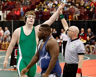 West Branch's Ian Sharp, left, is declared the winner against Sandusky's Jamez Young, center, following a semi-final 285 pound match during the Division II Ohio state wrestling tournament at the Ohio State University Friday, March 10, 2017. (Photo by Paul Vernon)