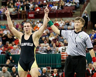 Canfield's David Crawford, left, is declared the winner in overtime  of a 170 pound championship match over New Lexington's Dimitri Williams during the Division II Ohio state wrestling tournament at the Ohio State University Saturday, March 11, 2017. (Photo by Paul Vernon)