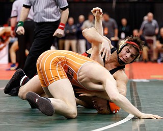 Canfield's Georgio Poullas, top, works against Claymont's Ashton Eyler in a semi-final 160 pound match during the Division II Ohio state wrestling tournament at the Ohio State University Friday, March 10, 2017. (Photo by Paul Vernon)