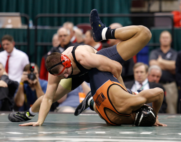 Canfield's David Crawford, left, scores against New Lexington's Dimitri Williams in overtime of a 170 pound championship match during the Division II Ohio state wrestling tournament at the Ohio State University Saturday, March 11, 2017. (Photo by Paul Vernon)