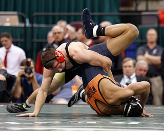 Canfield's David Crawford, left, scores against New Lexington's Dimitri Williams in overtime of a 170 pound championship match during the Division II Ohio state wrestling tournament at the Ohio State University Saturday, March 11, 2017. (Photo by Paul Vernon)