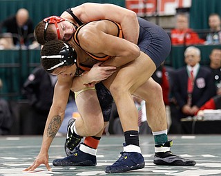 Canfield's David Crawford, top, works against New Lexington's Dimitri Williams in overtime of a 170 pound championship match during the Division II Ohio state wrestling tournament at the Ohio State University Saturday, March 11, 2017. (Photo by Paul Vernon)