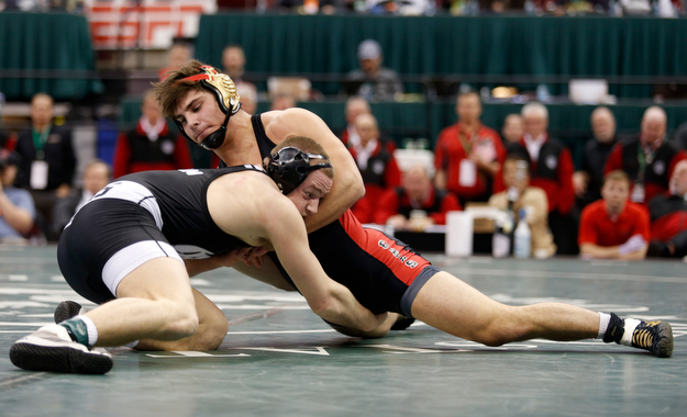 Canfield's Georgio Poullas, top, works against Graham Local's Ryan Thomas during a 160 pound championship match during the Division II Ohio state wrestling tournament at the Ohio State University Saturday, March 11, 2017. (Photo by Paul Vernon)