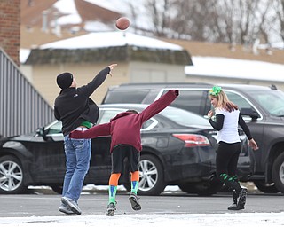 Kids throw a football to kill time before the Mahoning Valley St. Patrick's Day Parade on Market Street in Boardman, Sunday, March 12, 2017. ..(Nikos Frazier | The Vindicator)..