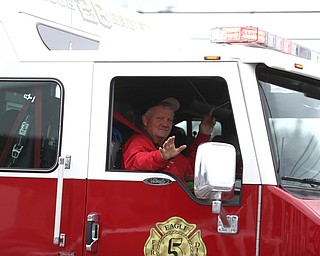 A member of the Hubbard Fire Department waves during the Mahoning Valley St. Patrick's Day Parade on Market Street in Boardman, Sunday, March 12, 2017. ..(Nikos Frazier | The Vindicator)..
