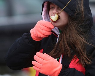 Kaydence Heubel, 11, of Boardman tries a smoked potato during the Mahoning Valley St. Patrick's Day Parade on Market Street in Boardman, Sunday, March 12, 2017. ..(Nikos Frazier | The Vindicator)..