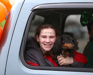A girl smiles with her dog during the Mahoning Valley St. Patrick's Day Parade on Market Street in Boardman, Sunday, March 12, 2017. ..(Nikos Frazier | The Vindicator)..