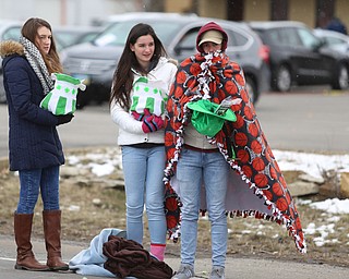 (from right) Michael Moreschi, 18, Allegra Deley, 17, and Leigha Cameron of Mineral Ridge brave the cold to watch the Mahoning Valley St. Patrick's Day Parade on Market Street in Boardman, Sunday, March 12, 2017. ..(Nikos Frazier | The Vindicator)..