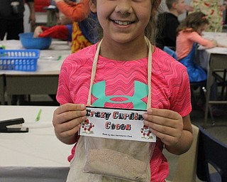 Neighbors | Abby Slanker.A C.H. Campbell Elementary School third-grader held up the final hot cocoa product during the school’s Hot Chocolate Shoppe on Feb. 2.