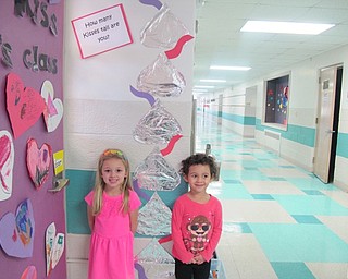 Neighbors | Alexis Bartolomucci.Students in Samantha Cox's class stood next to Hershey's Kisses to see how many Kisses tall they were for Valentine's Day.