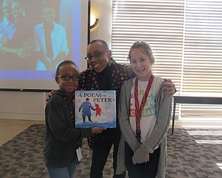 Neighbors | Alexis Bartolomucci.Two Austintown Intermediate School students stood with Andrea Davis Pinkney after listening to her presentation at the Austintown library on Feb. 24. Pictured are, from left, Serena Robinson, Andrea Davis Pinkney and Gianna Franklin.