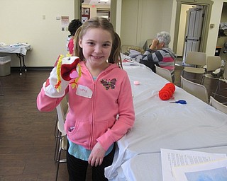 Neighbors | Alexis Bartolomucci.Sydney posed with the sock puppet she made during the Puppet Project program at the Boardman library on Feb. 20.