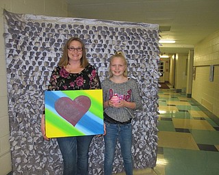 Neighbors | Alexis Bartolomucci.Heather and Kayla Cetor held a canvas and cupcake prop for their picture during the Cupcakes and Canvas event at Dobbins Elementary on Feb. 23.