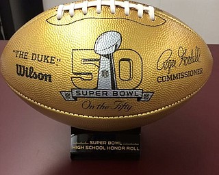 Neighbors | Submitted.The BHS football team was gifted two golden footballs by the NFL in recognition of two Boardman alumni football players playing in the Super Bowl. The balls each had the name of the Boardman Football alumni, Bernie Kosar and Steve Vallos, printed on them.