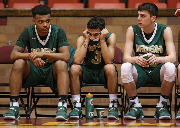 MICHAEL G TAYLOR | THE VINDICATOR- 03-16-17  -Basketball-  4th qtr, on the bench, Ursuline's #10 Dawalyn Washington, #3 Anise Algahmee and #22 Vince Venzeio react to Ursuline's loss .  D2 Regional Semi Final-  Ursuline Irish vs Cleve Central Catholic Iromen at Canton Memorial Civic Center in Canton, OH