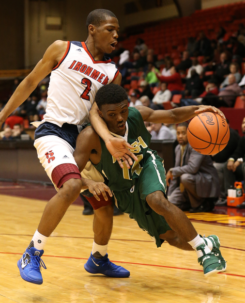 MICHAEL G TAYLOR | THE VINDICATOR- 03-16-17  -Basketball-  4th qtr, Ursuline's #14 Dakota Hobbs drives against Ironmen's #2 Dion Ivory.  D2 Regional Semi Final-  Ursuline Irish vs Cleve Central Catholic Iromen at Canton Memorial Civic Center in Canton, OH