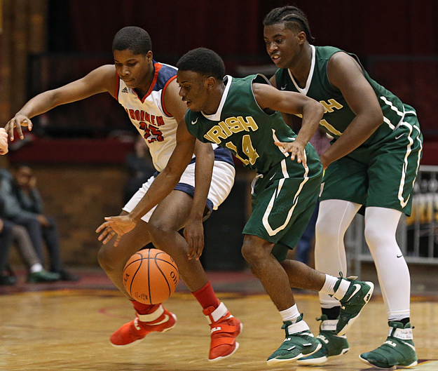 MICHAEL G TAYLOR | THE VINDICATOR- 03-16-17  -Basketball-  4th qtr, Ursuline's #14 Dakota Hobbs steals the ball from Ironmen's #25 Trevon Wells as #1 Anthony Howell looks on.  D2 Regional Semi Final-  Ursuline Irish vs Cleve Central Catholic Iromen at Canton Memorial Civic Center in Canton, OH