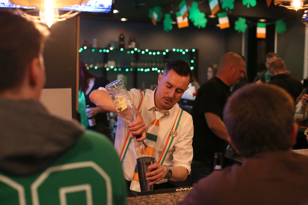 Eric Darino, a bartender at The Federal serves drinks during Sham-Rock on the Block, Friday, March 17, 2017, in downtown Youngstown. ..(Nikos Frazier | The Vindicator)..