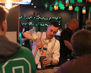 Eric Darino, a bartender at The Federal serves drinks during Sham-Rock on the Block, Friday, March 17, 2017, in downtown Youngstown. ..(Nikos Frazier | The Vindicator)..