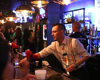 Eric Darino, a bartender at The Federal serves drinks during Sham-Rock on the Block, Friday, March 17, 2017, in downtown Youngstown. ..(Nikos Frazier | The Vindicator)..