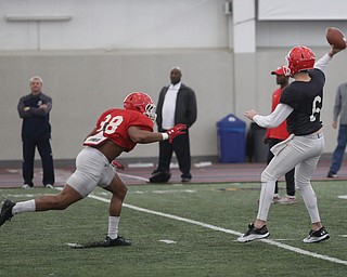 Youngstown senior quarterback Hunter Wells(6) scrambles to throw as junior wide reciever Michael Callender(88) bears down during practice at the Watson and Tressel Training Site, Friday, March 17, 2017, in Youngstown. ..(Nikos Frazier | The Vindicator)..