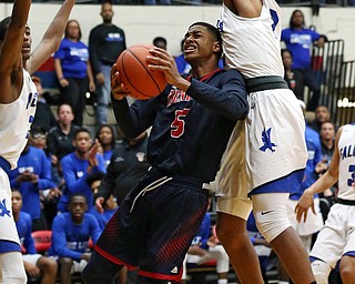 MICHAEL G TAYLOR | THE VINDICATOR- 03-17-17  -Basketball- 1st qtr, JFK's #5 Bryon Taylor drives to the hoop against Falcon's #3 Tyler Powell.  D4 Regional Final, Cleve Luthern East Falcons vs JFK Eagles at Canton Fieldhouse in Canton, OH