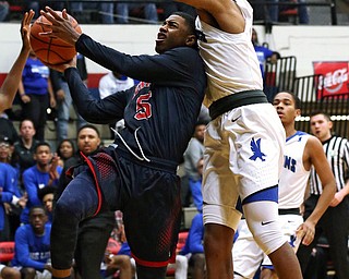 MICHAEL G TAYLOR | THE VINDICATOR- 03-17-17  -Basketball- 1st qtr, JFK's #5 Bryon Taylor drives to the hoop against Falcon's #3 Tyler Powell.  D4 Regional Final, Cleve Luthern East Falcons vs JFK Eagles at Canton Fieldhouse in Canton, OH