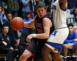 MICHAEL G TAYLOR | THE VINDICATOR- 03-17-17  -Basketball- 1st qtr, JFK's #33 Justin Bofenkamp drives to the hoop against Falcon's #5 Kaylin Heard.  D4 Regional Final, Cleve Luthern East Falcons vs JFK Eagles at Canton Fieldhouse in Canton, OH