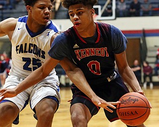 MICHAEL G TAYLOR | THE VINDICATOR- 03-17-17  -Basketball- 1st qtr, JFK's #0 Hyland Burton drives to the hoop against Falcon's #25 Jordan Burge.  D4 Regional Final, Cleve Luthern East Falcons vs JFK Eagles at Canton Fieldhouse in Canton, OH