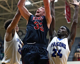 MICHAEL G TAYLOR | THE VINDICATOR- 03-17-17  -Basketball- 1st qtr, JFK's #33 Justin Bofenkamp scores against Falcon's #25 Jordan Burge and Falcon's #24 Travis Sanders.  D4 Regional Final, Cleve Luthern East Falcons vs JFK Eagles at Canton Fieldhouse in Canton, OH