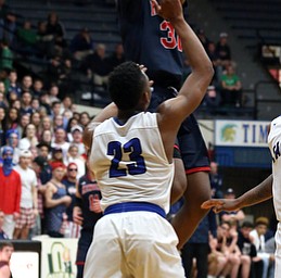 MICHAEL G TAYLOR | THE VINDICATOR- 03-17-17  -Basketball- 2nd qtr, JFK's #31 Nate Woods fires a shot over Falcon's #23 Maurico Tate. D4 Regional Final, Cleve Luthern East Falcons vs JFK Eagles at Canton Fieldhouse in Canton, OH