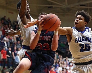 MICHAEL G TAYLOR | THE VINDICATOR- 03-17-17  -Basketball- 2nd qtr, JFK's #33 Justin Bofenkamp drives  to the hoop against Falcon's #25 Jordan Burge and Falcon's #35 Justin Motley.  D4 Regional Final, Cleve Luthern East Falcons vs JFK Eagles at Canton Fieldhouse in Canton, OH