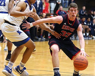 MICHAEL G TAYLOR | THE VINDICATOR- 03-17-17  -Basketball- 2nd qtr, JFK's #33 Justin Bofenkamp drives  to the hoop against Falcon's #25 Jordan Burgy.  D4 Regional Final, Cleve Luthern East Falcons vs JFK Eagles at Canton Fieldhouse in Canton, OH