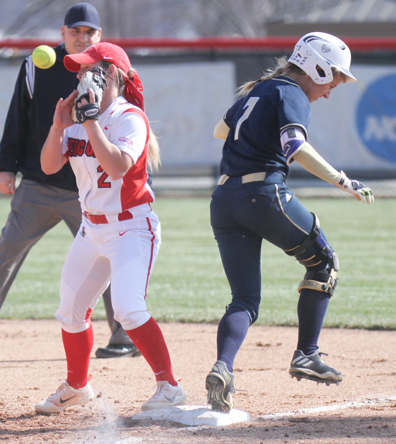William D. Lewis The Vindicator  Akron's Ashley Sims(7) is safe at 2nd as YSU's  Brittney Moffatt(2) loses control of the ball during 3-21-17 game at YSU.