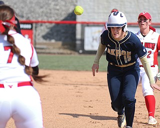 William D. Lewis The Vindicator  Akron's Alyssa Nicholas(15) is caught in a run down between YSU's first baseman Kelly Thompson Cappadocio(7) and Brittney Moffatt(2) during 3-21-17 game at YSU.