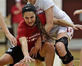 BOARDMAN, OHIO - MARCH 21, 2017: Makayla Trebella, red, fights for a loose ball against Karli Shives, white, during the second half of the 2017 Al Beach Classic, Tuesday night at Boardman High School. DAVID DERMER | THE VINDICATOR