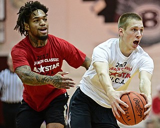 BOARDMAN, OHIO - MARCH 21, 2017: Pat Pelini, white, dribbles around Lynn Bowden, red, during the first half of the 2017 Al Beach Classic, Tuesday night at Boardman High School. DAVID DERMER | THE VINDICATOR