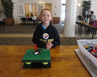 Neighbors | Alexis Bartolomucci.Christian played at the earthquake station at the Austintown library I Survived program on March 11.