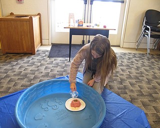 Neighbors | Alexis Bartolomucci.Olivia filled her volcano with vinegar and baking soda to see it overflow like lava during the I Survived event at the Austintown library.