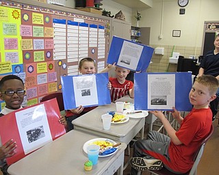 Neighbors | Alexis Bartolomucci.Students held up the American Revolution projects they created during their reading workshop at Robinwood Lane Elementary.