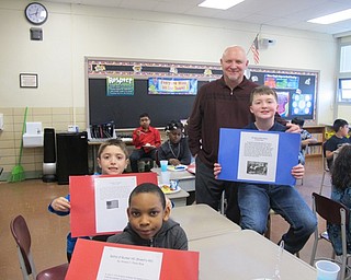 Neighbors | Alexis Bartolomucci.Robinwood Lane Elementary school principal Don Robinson stood with fourth-grade students as they held up their American Revolution projects on March 9.
