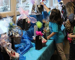 Neighbors | Abby Slanker.A C.H. Campbell Elementary School student put a ticket in the bag for the Chinese auction basket she wanted to win during the school’s annual ‘Under the Sea’ Spring Fest on March 10.