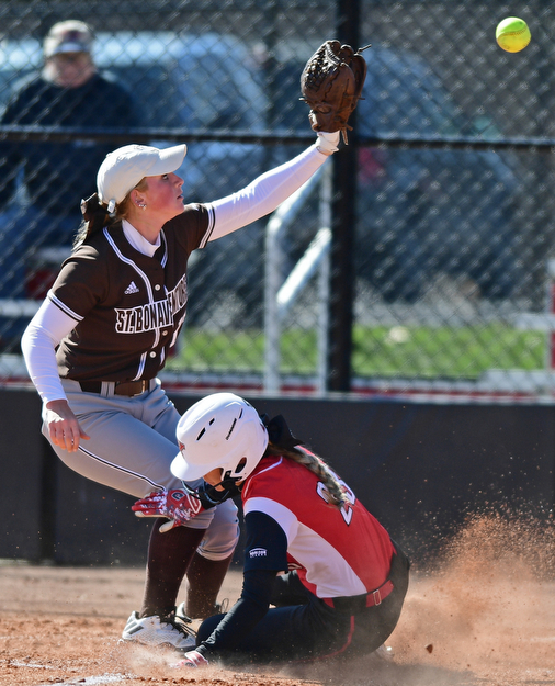 YOUNGSTOWN, OHIO - MARCH 23, 2017: Lexi Zappitelli #23 of YSU slides across home plate beating a tag from pitcher Rylee Hehir #17 of St. Bonaventure after a while pitch by Hehir, in the the second inning of game one of, Thursday afternoons game at Youngstown State. DAVID DERMER | THE VINDICATOR