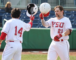 William D. Lewis The Vindicator YSU's Andrew Kendrick (21) gets congrats from Anthony Rohan(14) after homering during 3-24-17 opener with Oakland at Eastwood.