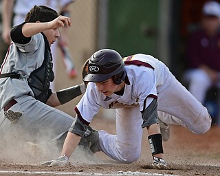 STRUTHERS, OHIO - MARCh 25, 2017: Jared Bajerski #18 of South Range crawls to touch home plate to score a run after colliding with catcher Evan Kanus #17 of Boardman could not hold the baseball in the second inning of Saturday evenings game. South Range won 4-3 in 10 innings. DAVID DERMER | THE VINDICATOR